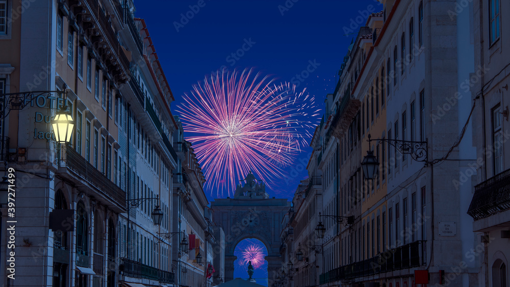 Celebratory fireworks for new year over rua augusta arch in lisbon - Portugal near the  Praca do Comercio (the Commerce Square) during last night of year. Christmas atmosphere