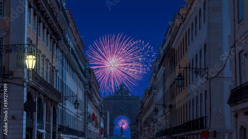 Celebratory fireworks for new year over rua augusta arch in lisbon - Portugal near the  Praca do Comercio (the Commerce Square) during last night of year. Christmas atmosphere