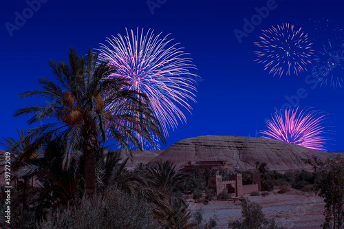 Celebratory fireworks for new year over Kasbah Ait Ben Haddou on the Atlas mountain of Morocco. UNESCO World Heritage Site from 1987. Moment: during last night of year. Christmas atmosphere. 