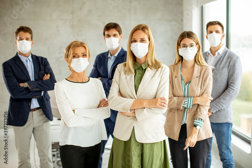 Business team members stand...
