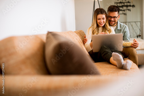 Young couple using laptop t...