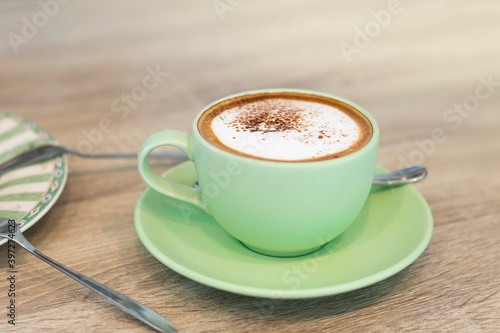 Green Cup Of Coffee Latte On Wooden Background, Close Up Of Art Coffee In Morning.