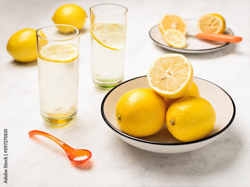 Lemons in a bowl and glasses of lemon juice drinks Lemons in a bowl and glasses of lemon juice drinks