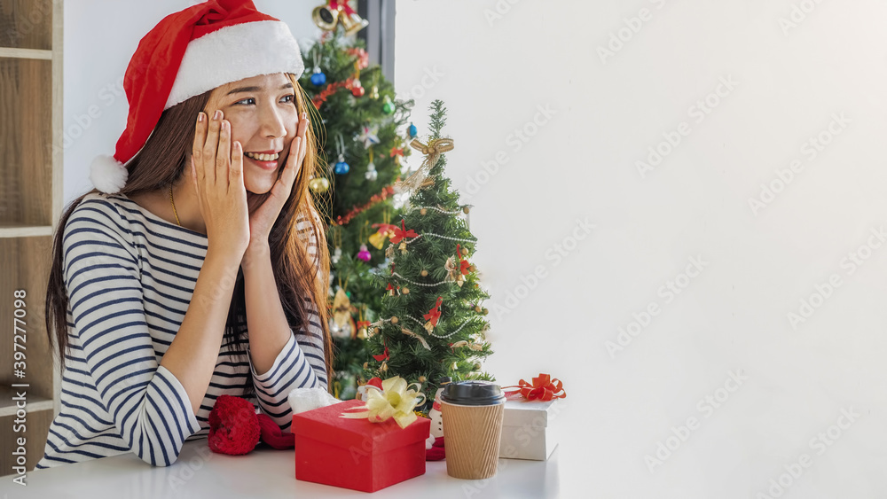 Happy Asian woman with a beautiful gift box on white table. Happy Christmas and Happy New Year. Happy Asian woman with a beautiful gift box on white table. Happy Christmas and Happy New Year.