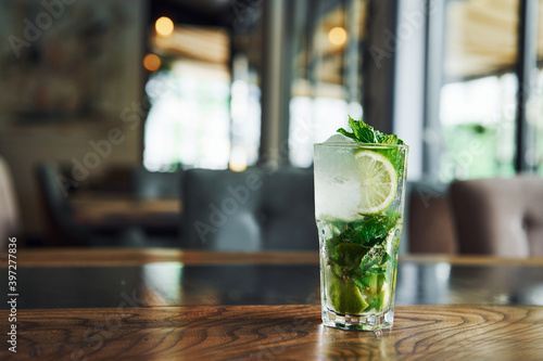 Close up view of fresh summer non alcoholic mojito cocktail on the wooden table