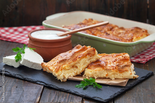 Homemade Traditional Serbian Gibanica with cheese. Delicious soft cheese pie, cut and layed on backing paper