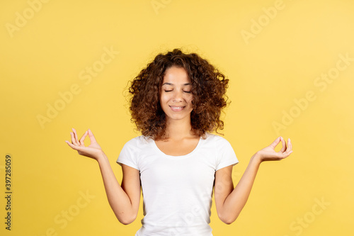 Young afro american woman on yellow copy space background © brizmaker