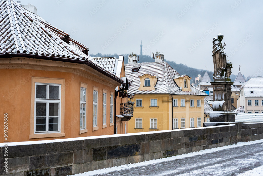 Classic fairytale winter view on old Prague over snow capped roofs, Christmas time in Czech Republic. 