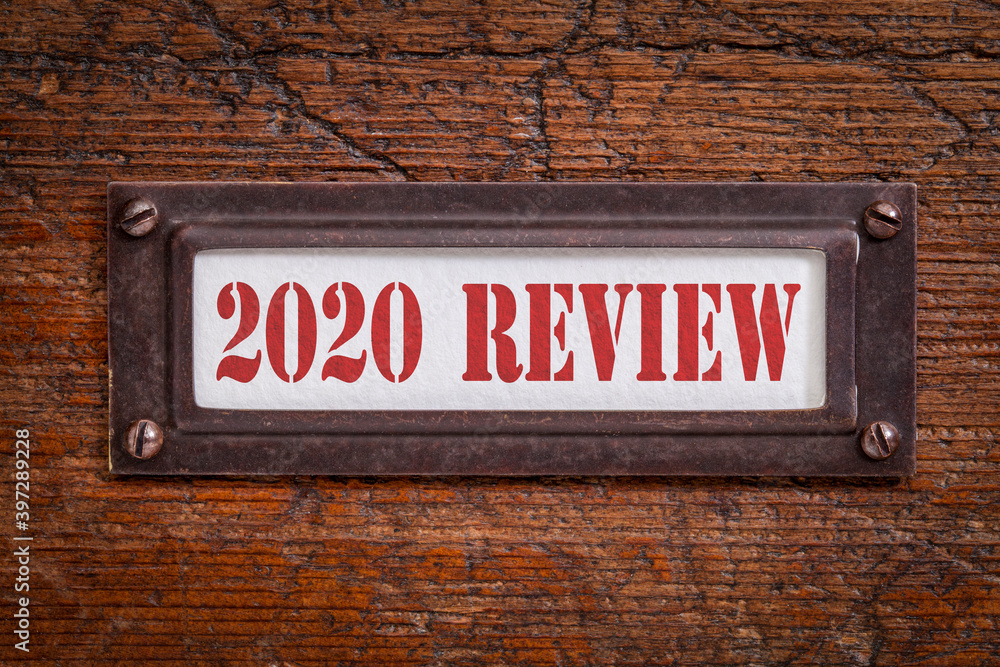 2020 review - a label on grunge wooden file cabinet. A passing year evaluation, summary and review concept. 2020 review - a label on grunge wooden file cabinet. A passing year evaluation, summary and review concept.