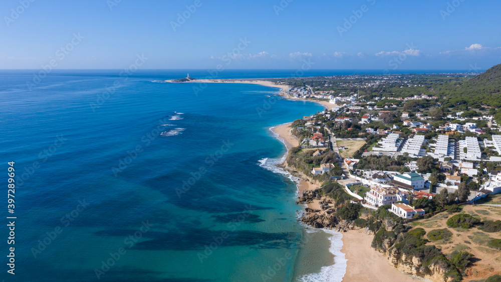 Aerial perspectives of a south Spanish beach in Andalusia with turquoise blue water. Andalusian Atlantic beach background. Ocean in Caños de Meca, Cádiz, Andalusia, Spain.
