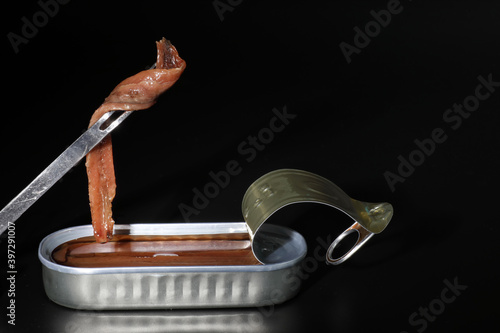Cantabrian anchovies in can with black background