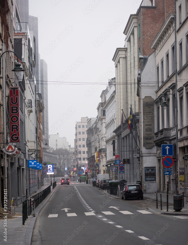 Fototapeta premium On the street car is moving. In the parking lot cars are located