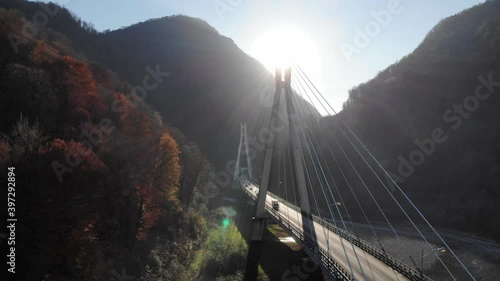 Aerial view forward flying of cable stayed bridge in Sochi, Krasnaya polyana, Russia. Epic cool flight over bridge. small Traffic on road. 4k.