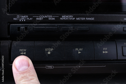 Press Rew button on retro audio cassette tape recorder. photo
