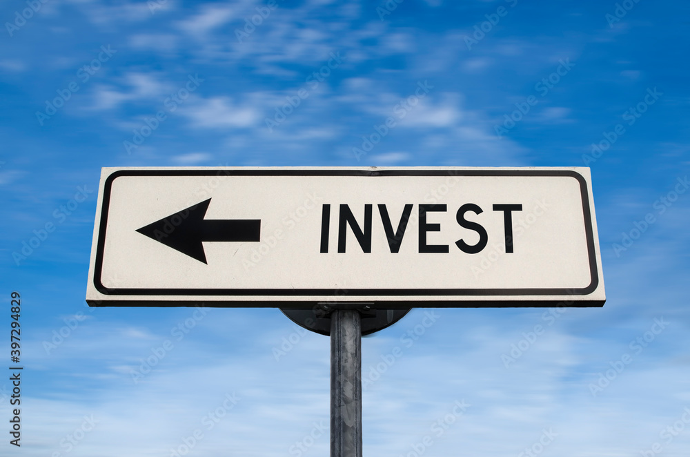 Invest road sign, arrow on blue sky background. One way blank road sign with copy space. Arrow on a pole pointing in one direction. Invest road sign, arrow on blue sky background. One way blank road sign with copy space. Arrow on a pole pointing in one direction.