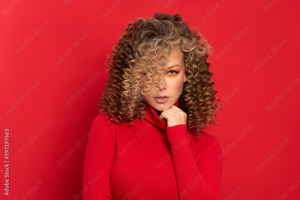beautiful young girl in a red jacket on a red background with a new year mood beautiful young girl in a red jacket on a red background with a new year mood