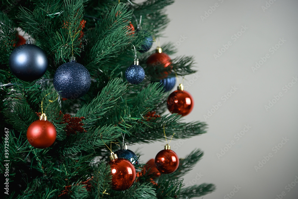 Decorated Christmas tree. Blue and red balloons, Christmas toys.