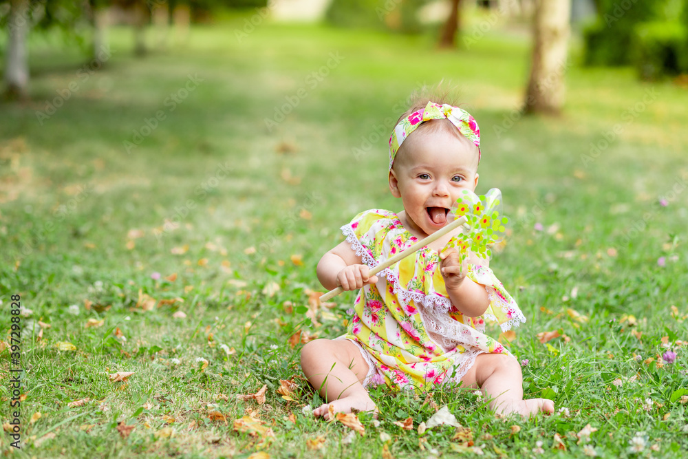 baby on the lawn walks in the summer in yellow clothes baby on the lawn walks in the summer in yellow clothes