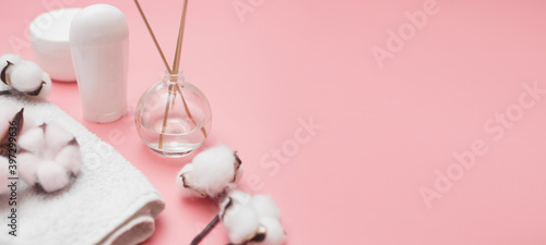 spa concept, cotton white jars on a pink background, copy space, top view