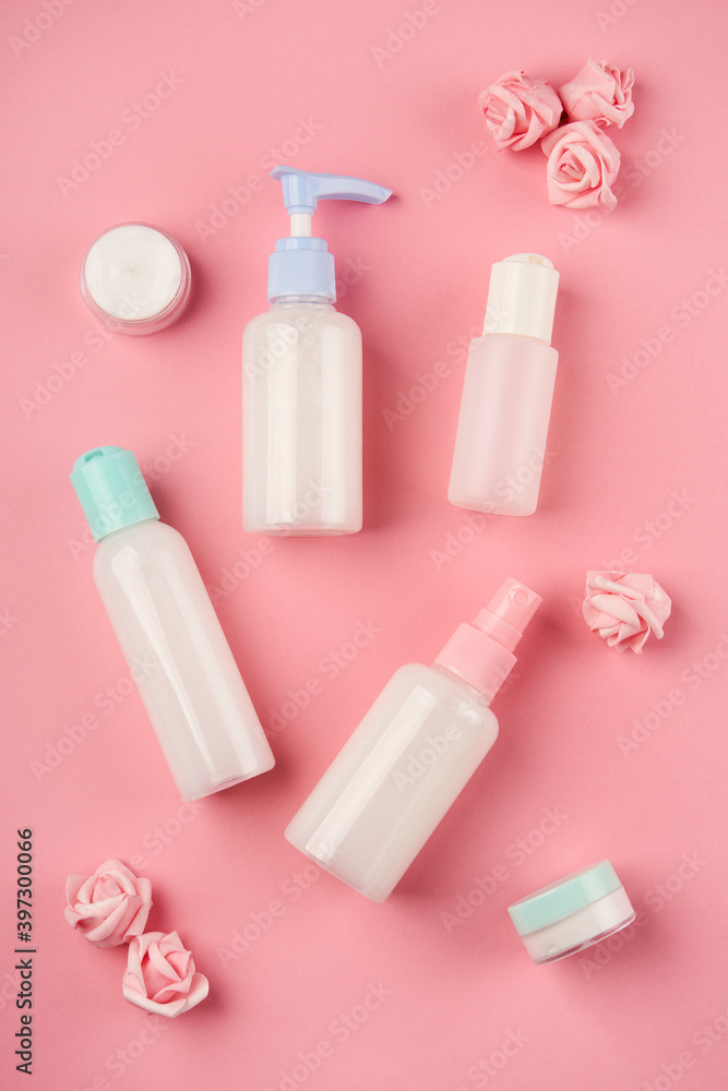 Packaging of cream, lotion, gel, facial foam or skin care with small flowers on pink background. Cosmetic beauty product branding mockup Packaging of cream, lotion, gel, facial foam or skin care with small flowers on pink background. Cosmetic beauty product branding mockup