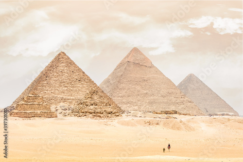 Bedouins on a camel in front of the Cheops pyramid.