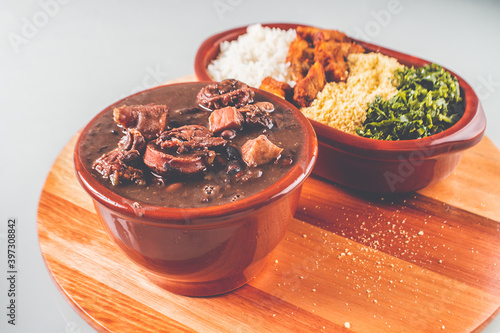 Foto Brazilian feijoada delivery menu with rice farofa pork meat cabbage crackling