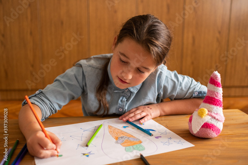 Cute little girl drawing at flat