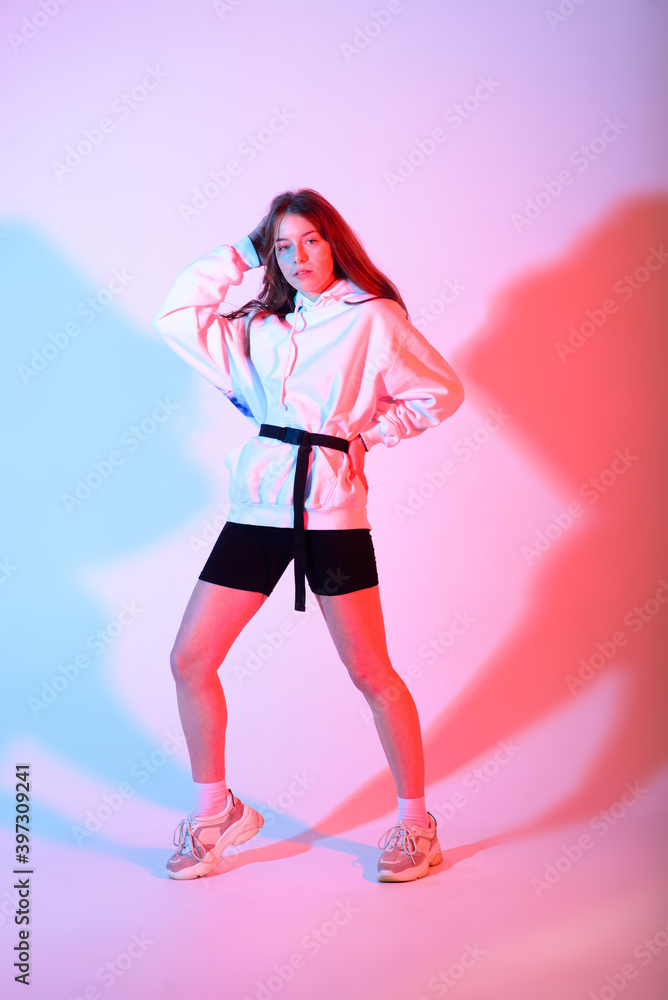 Young beautiful dancer posing on a studio background Young beautiful dancer posing on a studio background