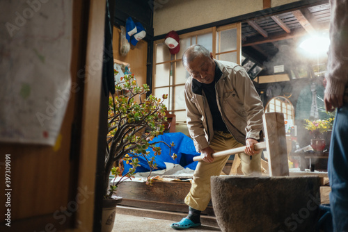 Japanese Old Man Pounding Cooked Rice to Make Mochi, Rice Cakes at Old House