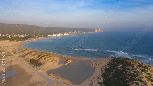 Drone views of the Cape of Trafalgar lighthouse on the Costa de la Luz in Caños de Meca, Cadiz Andalusia, Spain Beach from above on a beautiful day with clouds and the blue sea.