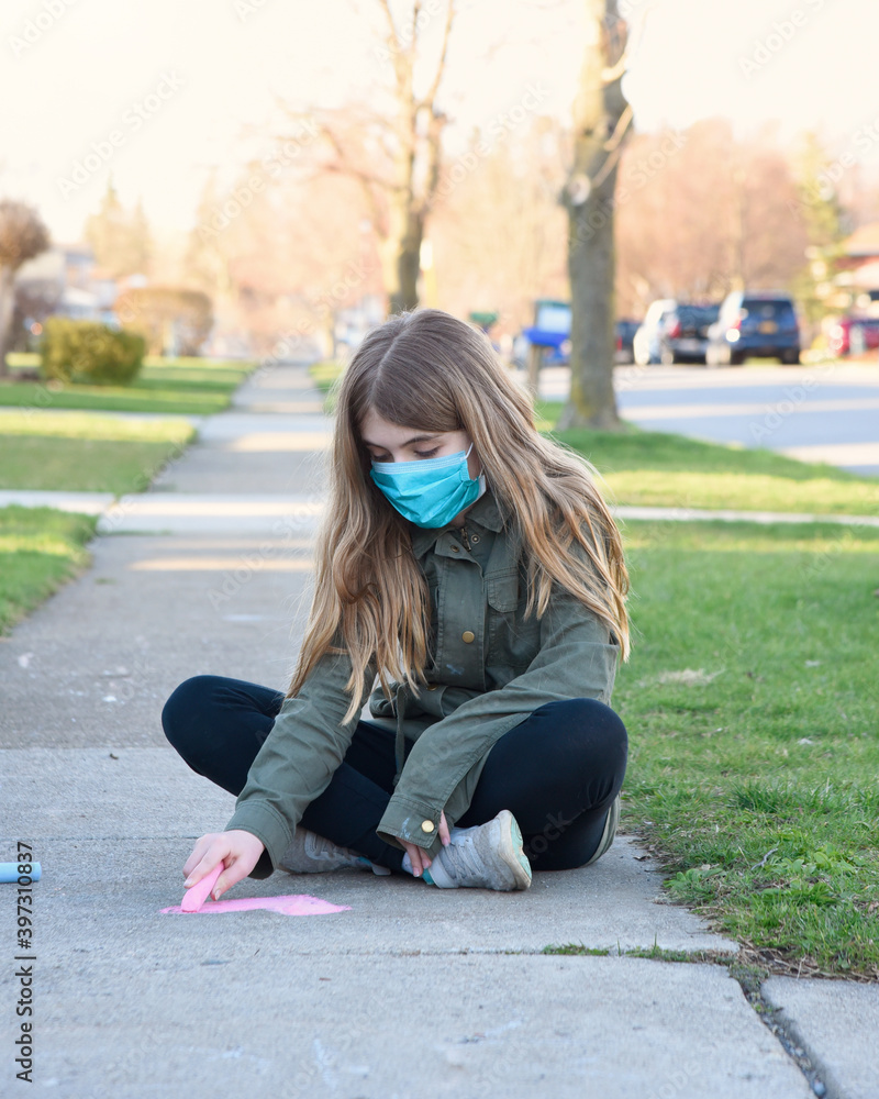 Child Drawing Heart Outside with Chalk with Mask