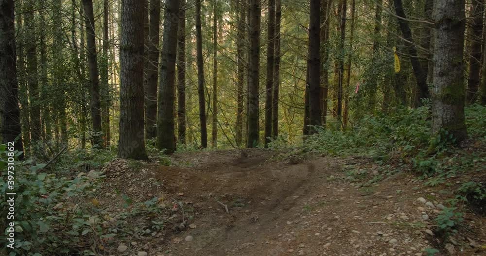 Thrilling Mountain Bike Air Off Dirt Jump to Skid Out on Forest Trail