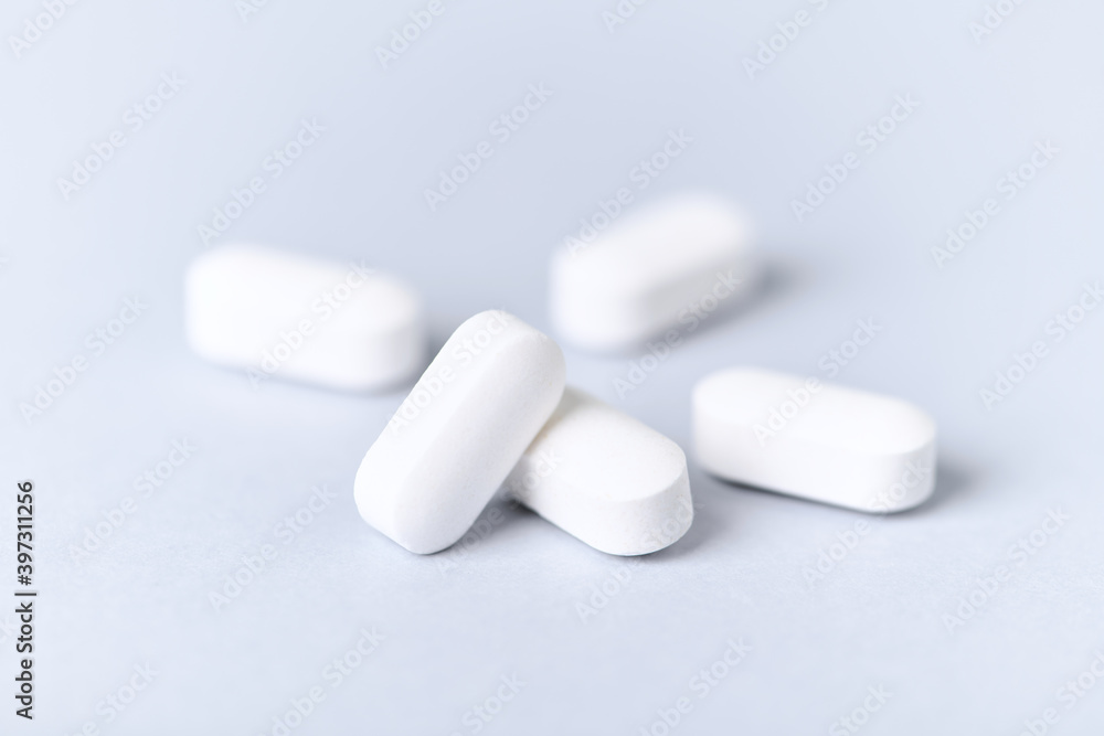 Carnitine tablets. Concept for a healthy dietary supplementation. Bright paper background. Soft focus. Close up. Carnitine tablets. Concept for a healthy dietary supplementation. Bright paper background. Soft focus. Close up.