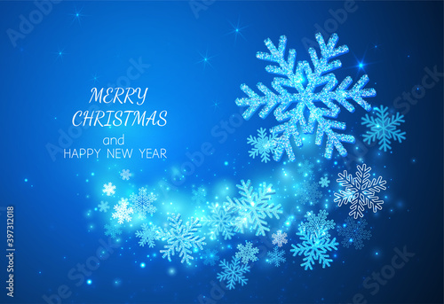 Happy New Year and Merry Christmas! Background for congratulations with sparkling snowflakes on a blue background. Glow and glitter with a spiral pattern.