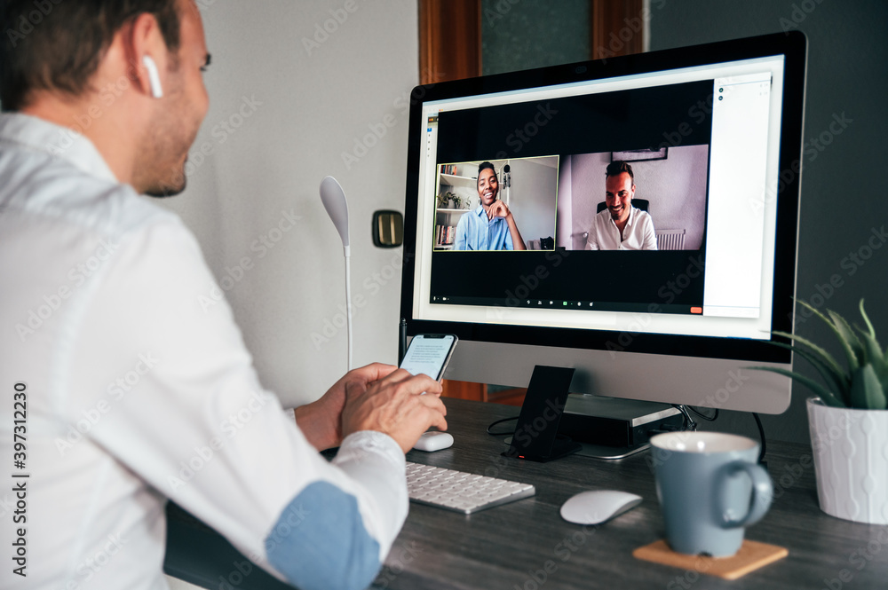 man at home working remote with a computer and making a video call with colleague man at home working remote with a computer and making a video call with colleague