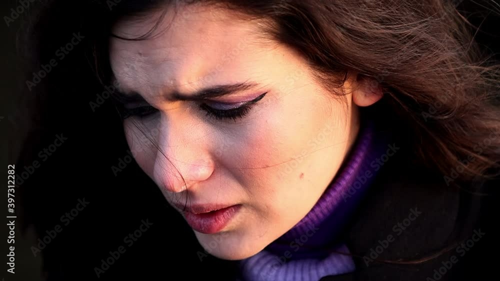 Ein Close-Up einer jungen Frau mit dunklen Haaren und lila Make-Up. Sie ist sehr traurig und fast am weinen. Ein Close-Up einer jungen Frau mit dunklen Haaren und lila Make-Up. Sie ist sehr traurig und fast am weinen.