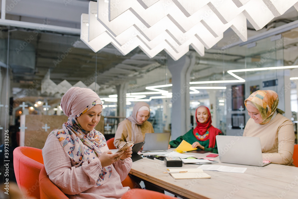 Islamic female fashion designers during work process in coworker space Islamic female fashion designers during work process in coworker space