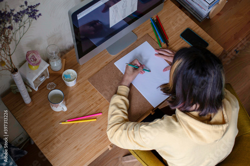 Pretty girl drawing at home photo