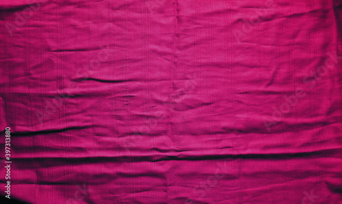 Crimson textured vibrant cloth with folds. Abstract backdrop. Wallpaper. Mock up.