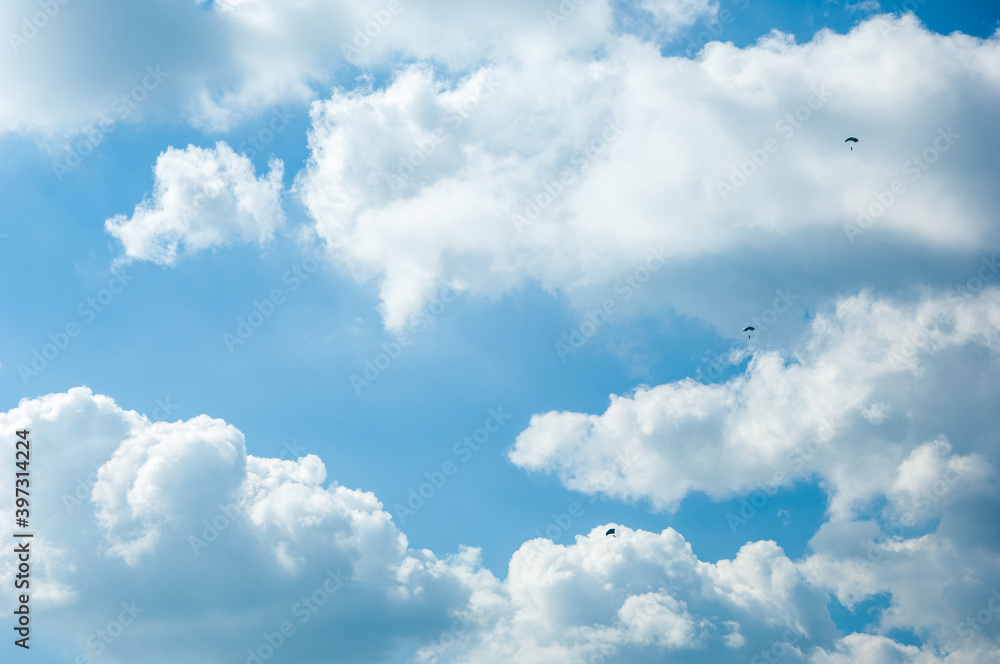 Group of paratroop parachuting against white clouds Group of paratroop parachuting against white clouds