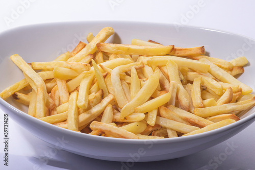 French fries make in oven on a white  plate
