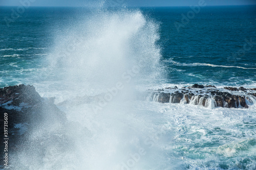 Waves crashing on rocky beach photo