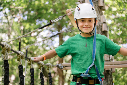 Caucasian boy balancing on rope bridge photo