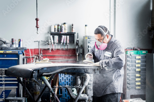 Hispanic mechanic working in auto shop photo