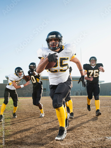 Football players playing on football field