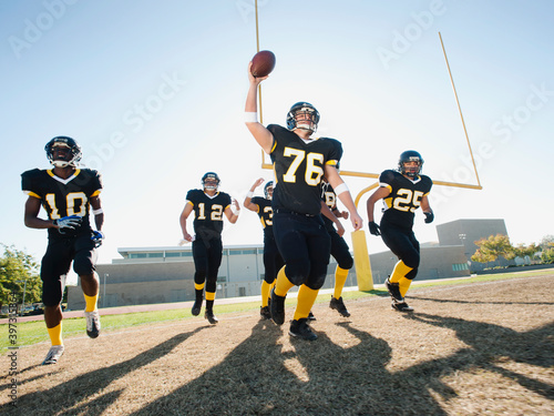 Football players celebrating on football field