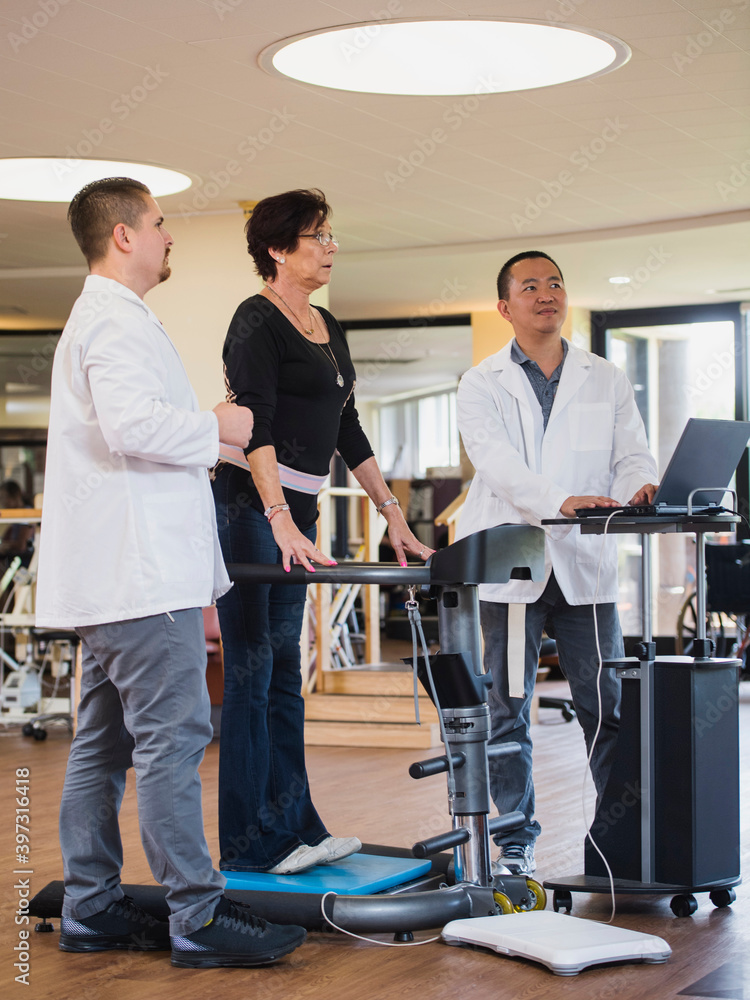 Physical therapists examining patient Physical therapists examining patient
