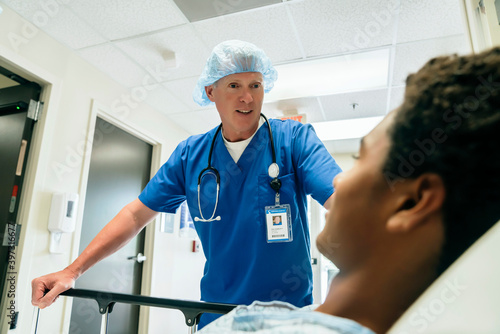 Nurse talking to boy in hospital bed