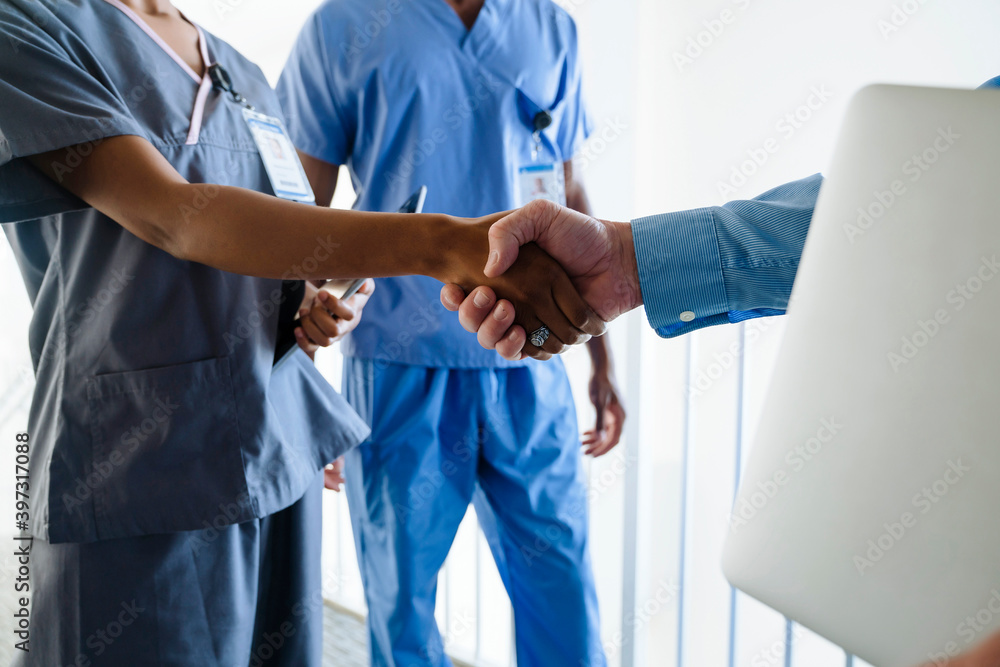 Doctor and nurse shaking hands Doctor and nurse shaking hands