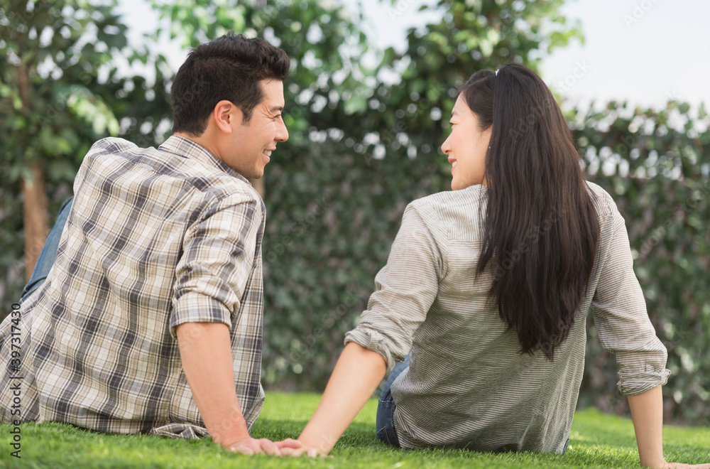 Couple relaxing together in grass Couple relaxing together in grass